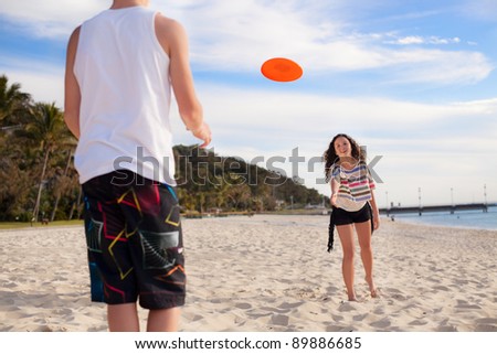 stock-photo-girl-playing-frisbee-on-the-beach-89886685.jpg