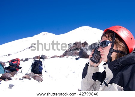 Girl with the wireless station on background of mountain