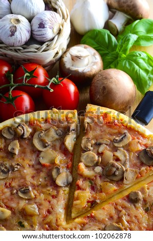 traditional italian pizza with mushrooms, tomatoes, garlic and basil