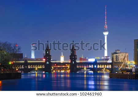 oberbaum bridge and tv tower in berlin, germany, at night