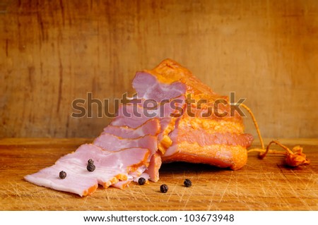 closeup of sliced smoked ham on a wooden background