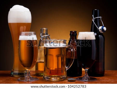 still life with different types of beer in glass and bottle