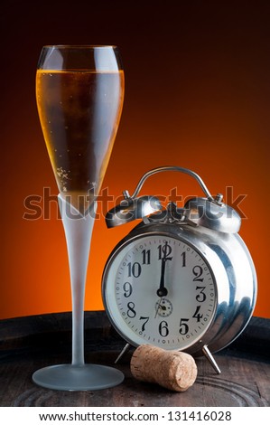 glass of champagne and old watch showing twelve oÃ?Â´clock