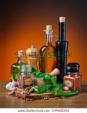 Still life with infused olive oil, herbs and various spices. The wording on the labels says \