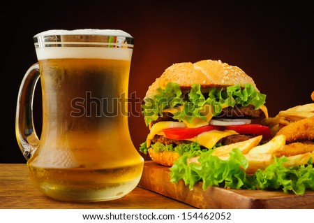 still life with fast food and fresh cold beer