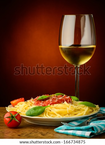 still life with traditional italian spaghetti pasta and white wine
