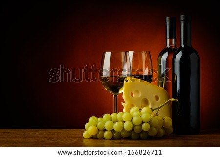 still life with cheese, grapes, red and white wine