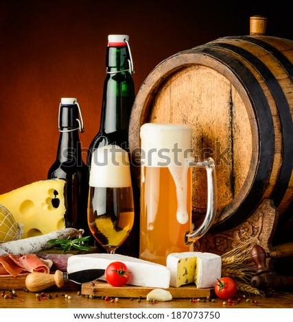 still life with beer traditional food and wooden barrel