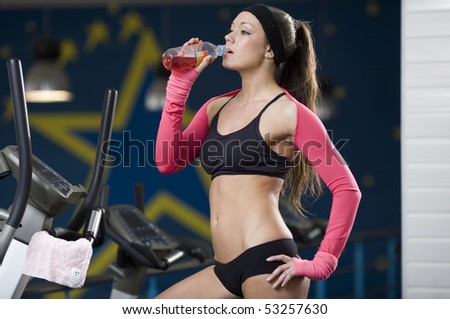 The young girl after training drinks water
