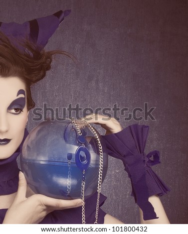 Half face of creative young woman in  blue with  sphere aquarium