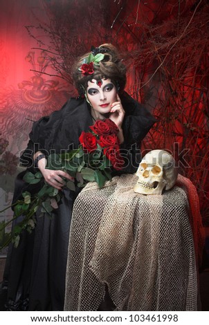 Spanish woman. Young woman in dramatic artistic image with rose\'s and skull