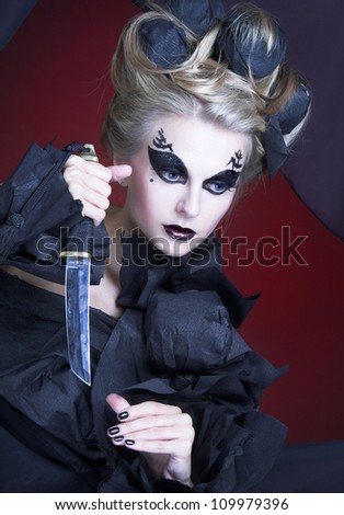 Creative woman. Woman in black and with knife.