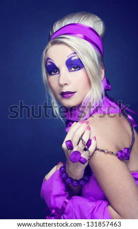 Young woman in violet with artistic visage and with retro hairstyle