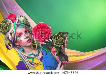 Summer fairy. Young woman in artistic image and with flowers in hair.