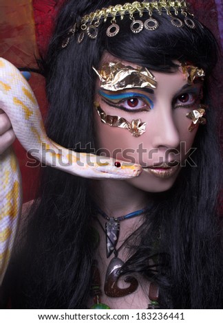Portrait of egyptian woman posing with white snake.