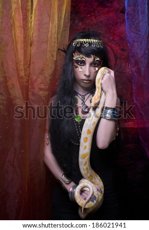 Portrait of egyptian woman posing with white snake.