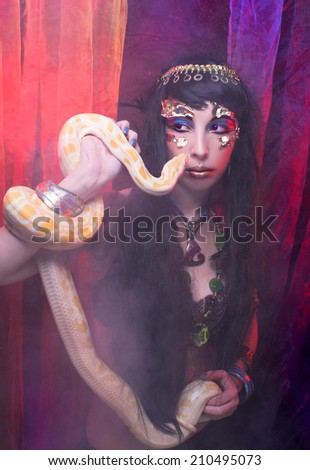 Halloween lady. Portrait of egyptian woman posing with white snake.