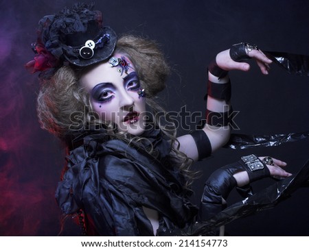 Halloween Doll. Young woman in holiday image of mystery gothic doll.