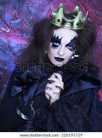 Halloween: The Mad queen. Young woman with creative visage and in crown