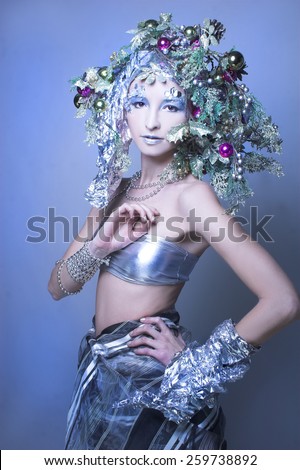Silver girl. Young woman in creative New Year image.