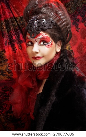 Young plump woman in creative image  in russian style  with artistic red and white visage