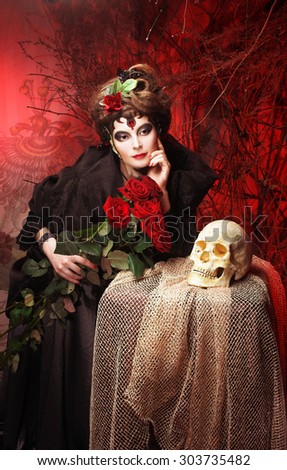 Halloween image. Young woman in dramatic artistic image with rose\'s and skull