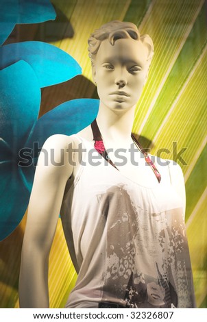 Modern clothing shop window with mannequin