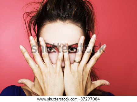 Fear. Portrait of young woman on red background.