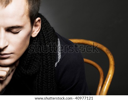 Portrait of young man in black scarf