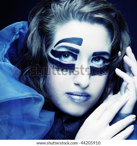 Romantic portrait of young lady with creative make-up in blue scarf