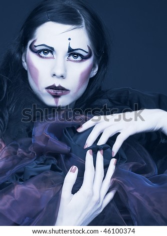 Portrait of young lady with creative make-up in cold tones