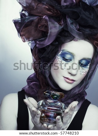 Young lady in doll style with vintage glass box in her hands