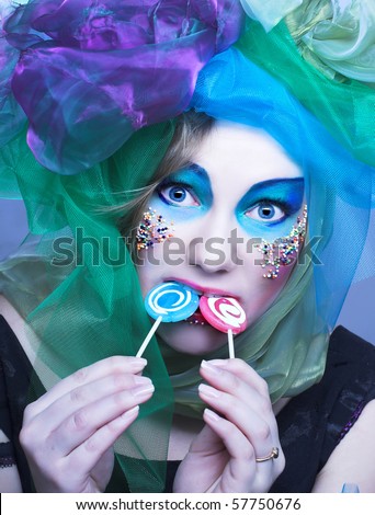 Young woman in doll-style with lolipop
