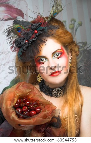Portrait of young creative lady with cherry.