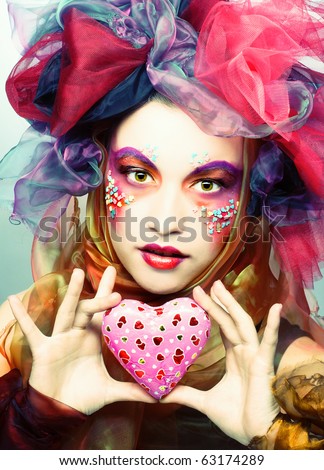 Young woman with creative make-up with chocolate heart
