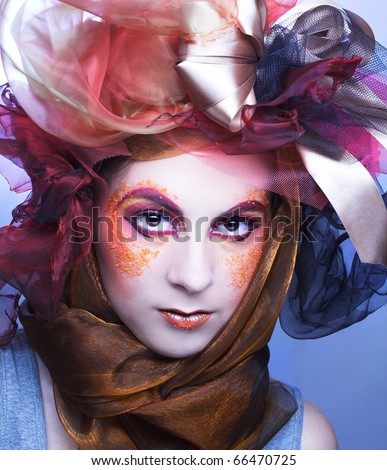 Portrait of young woman with creative make-up in doll style