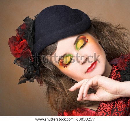 Portrait of pretty lady in vintage hat and with artistic make-up