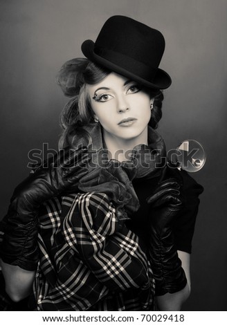 Detective. Young stylish lady in black hat and with loop.