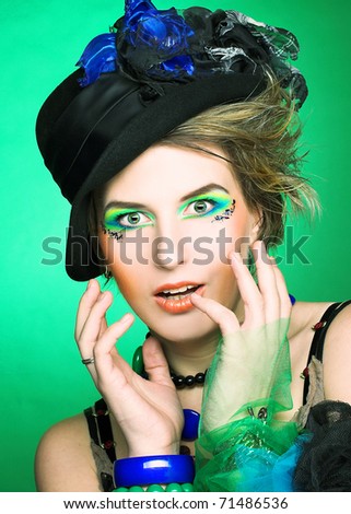 Portrait of pretty lady in vintage hat and with artistic make-up
