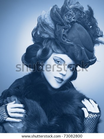 Vintage lady.Young pretty woman in black hat and furs.