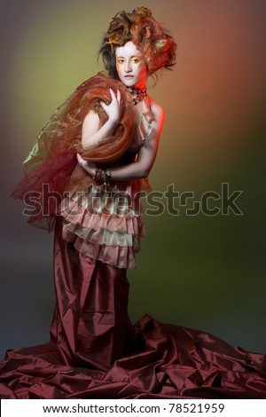 Porcelain princess. Young woman in orange dress and fat in retro style.