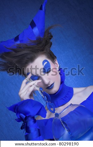 Creative young woman in  blue with  sphere aquarium