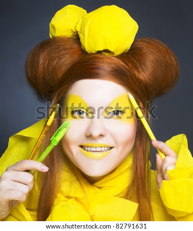 Girl in yellow. Portrait of young happy woman in artistic image.