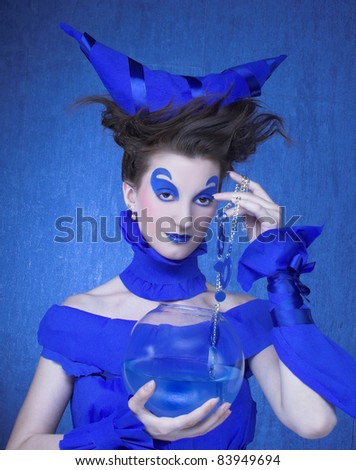 Creative young woman in  blue with  sphere aquarium