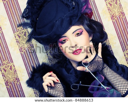 Detective. Young lady in vintage hat and with creative visage and forceps.