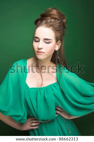 Portrait of young pretty woman in green dress