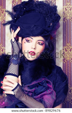 Vintage lady.Young pretty woman in black hat and furs.