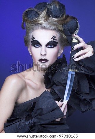 Creative woman. Woman in black and with knife.