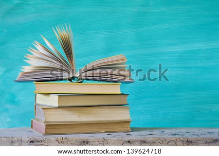 pile of books, one open, book arrangement, free copy space