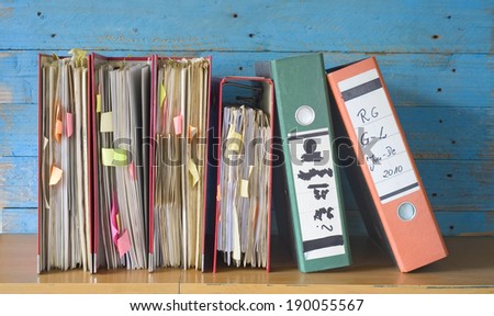 messy file folders, fictional labeling, bureaucracy concept